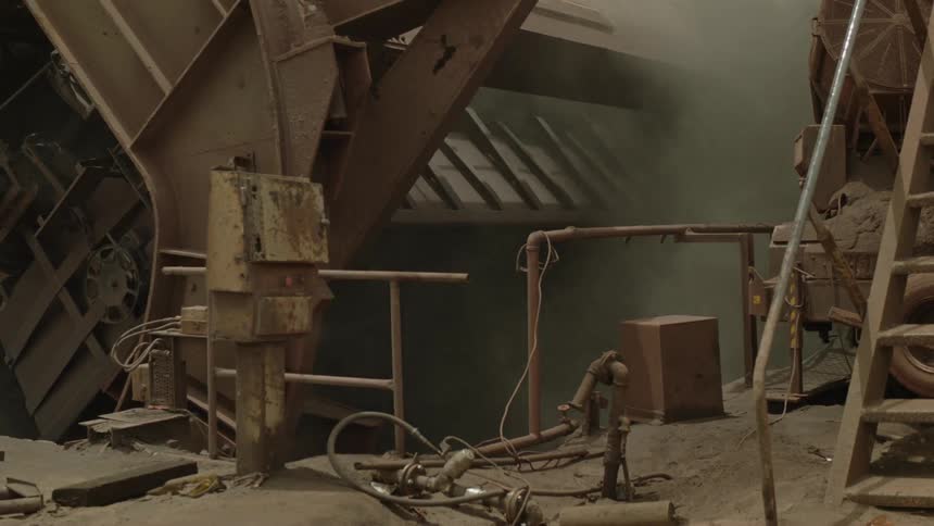 A machine dumping gravel into a hole