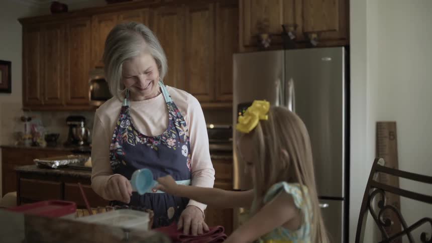 A woman and child cook in the kitchen