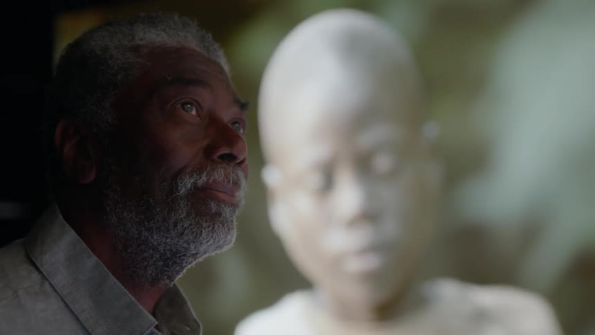 A man looks around as images are projected