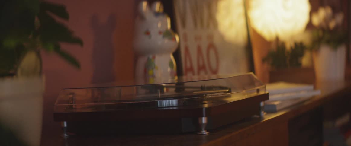 Knick knack sitting next to a digital clock on an end table