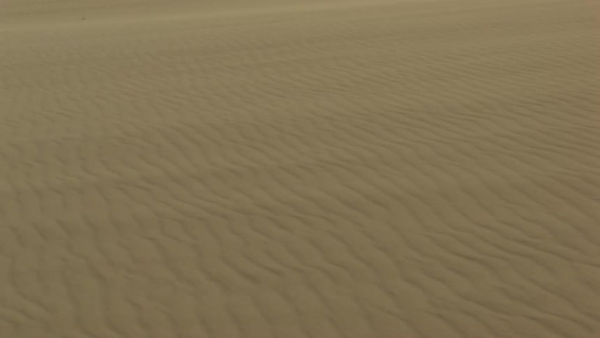 Wind blows across sand in a desert
