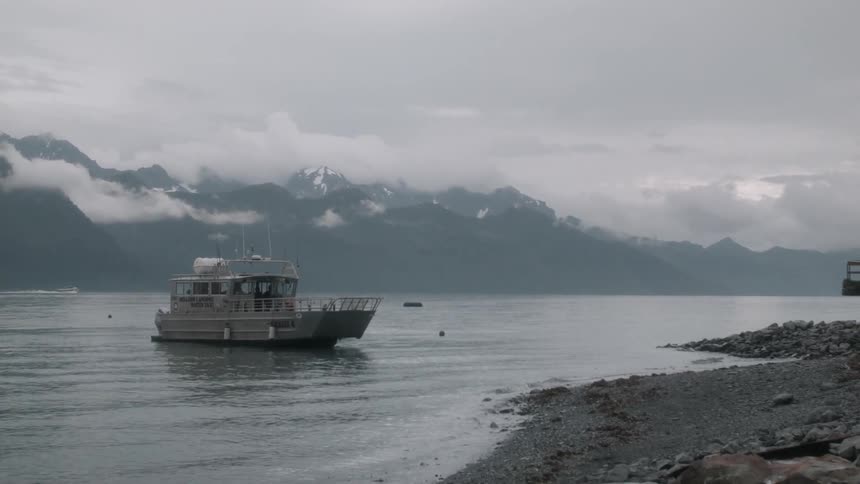A boat floats on a mountain lake