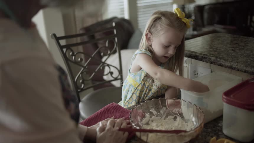 Woman and girl making cookies