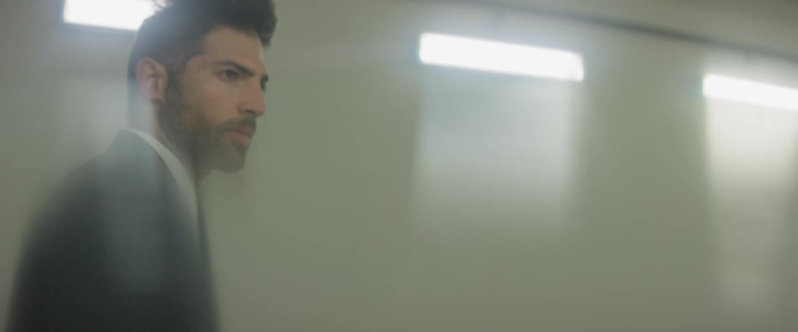 A man walks through a brightly lit building