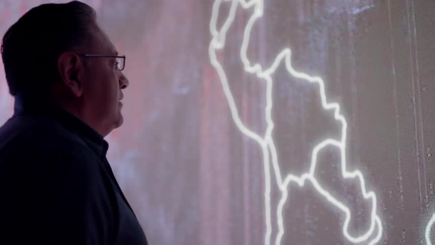 A man looks at images on LED wall
