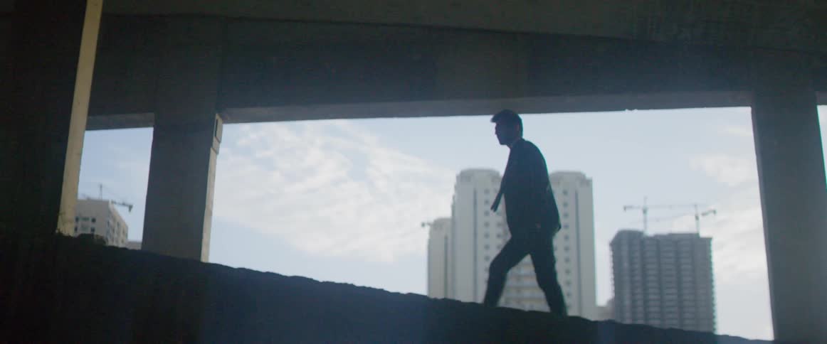 A man walking in a parking garage
