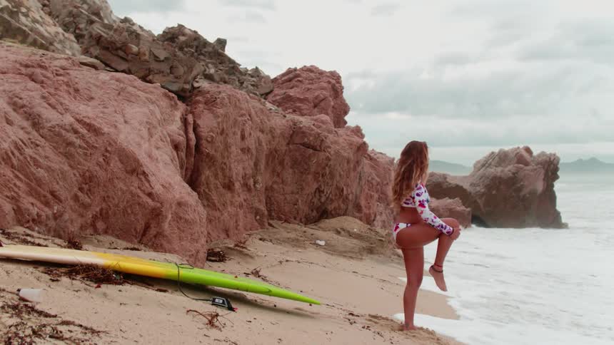 A woman stretches by the shore