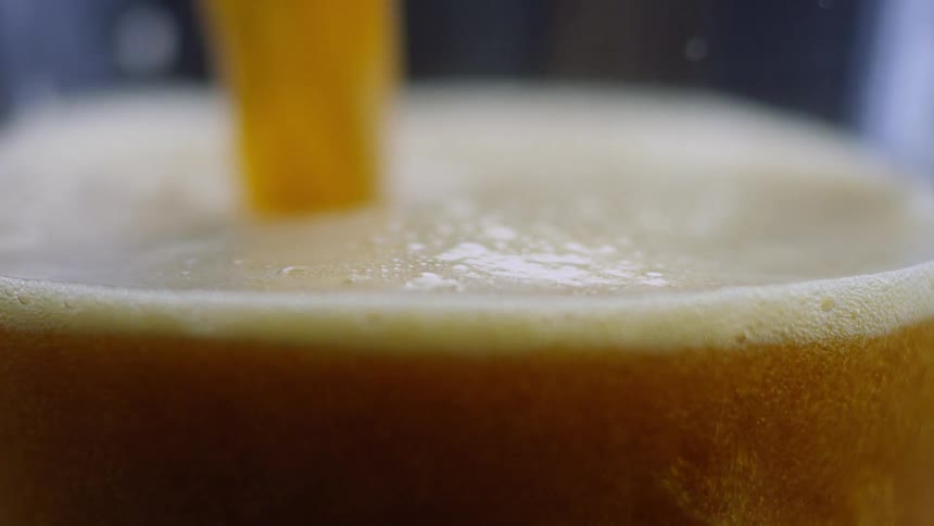 A glass is filled with beer
