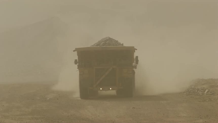A truck drives through a smoky area