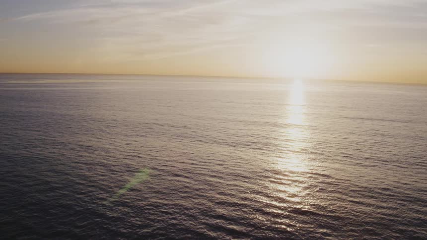 The sun rising over the ocean