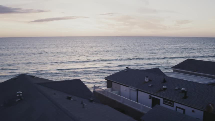 The homes are right on the shore at sunset