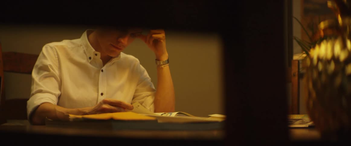 A man sits at the table looking through papers