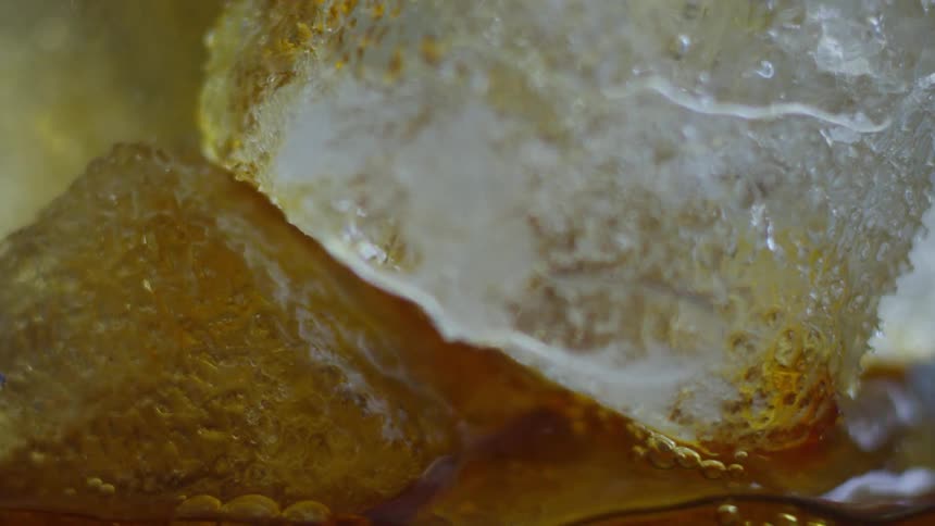 A drink is poured over ice
