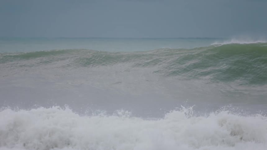 A person is riding a wave on their surfboard