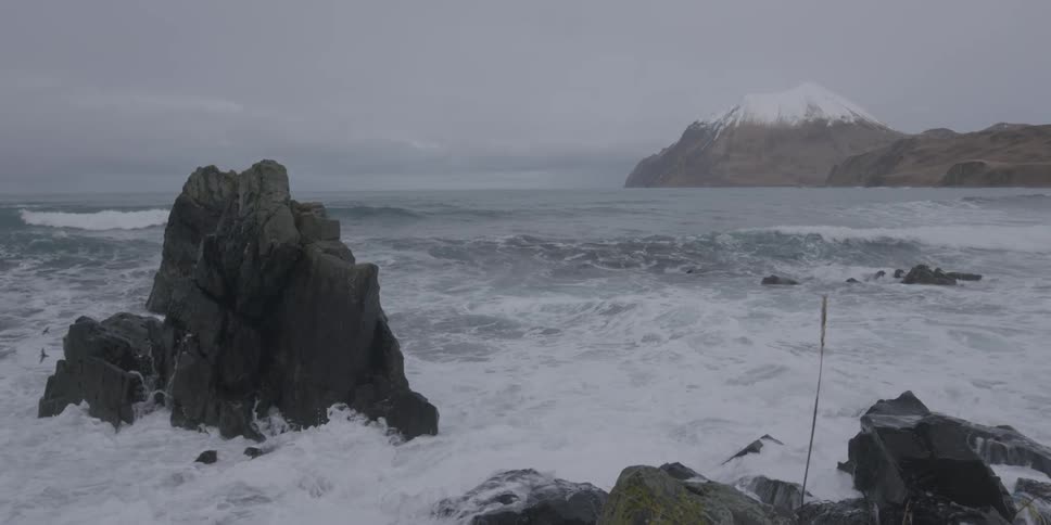 Ocean waves crash into a rocky shore