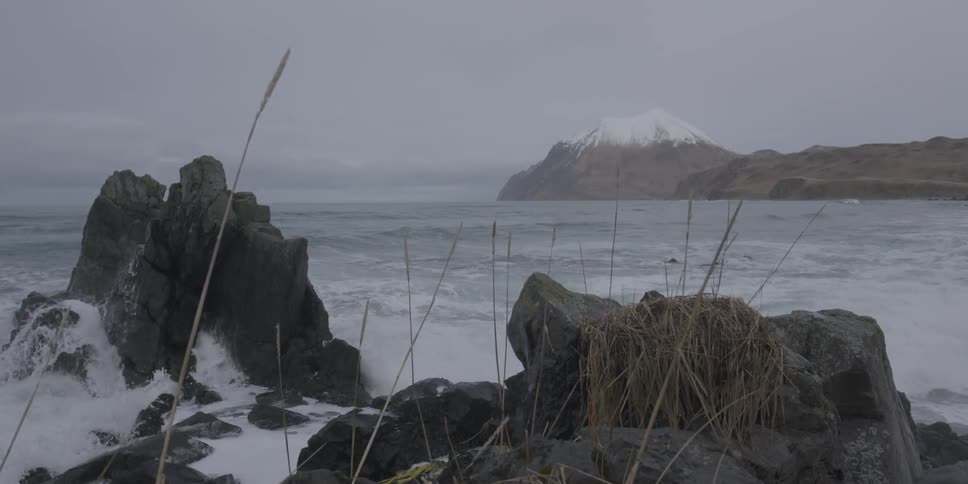 Ocean waves crash into a rocky shore