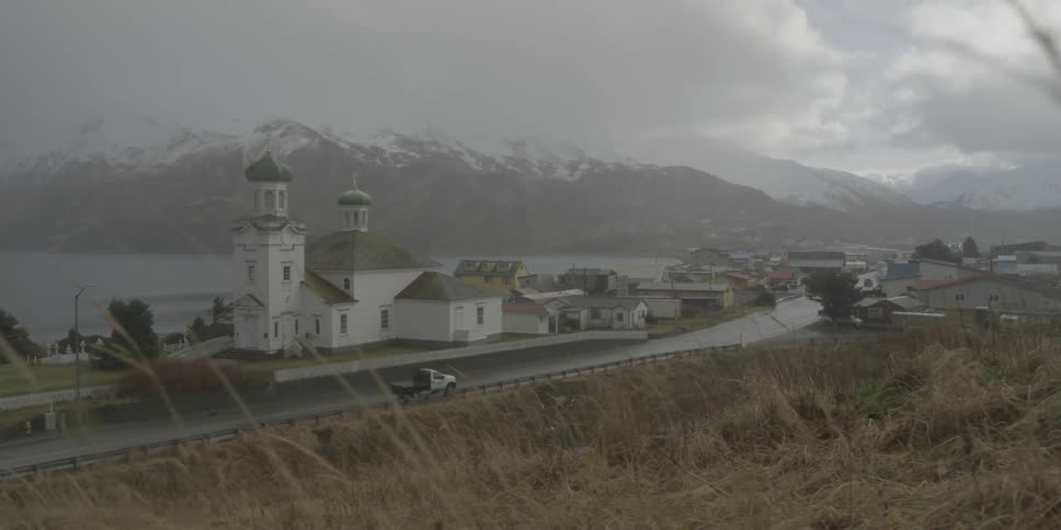 A truck drives down the road near the town