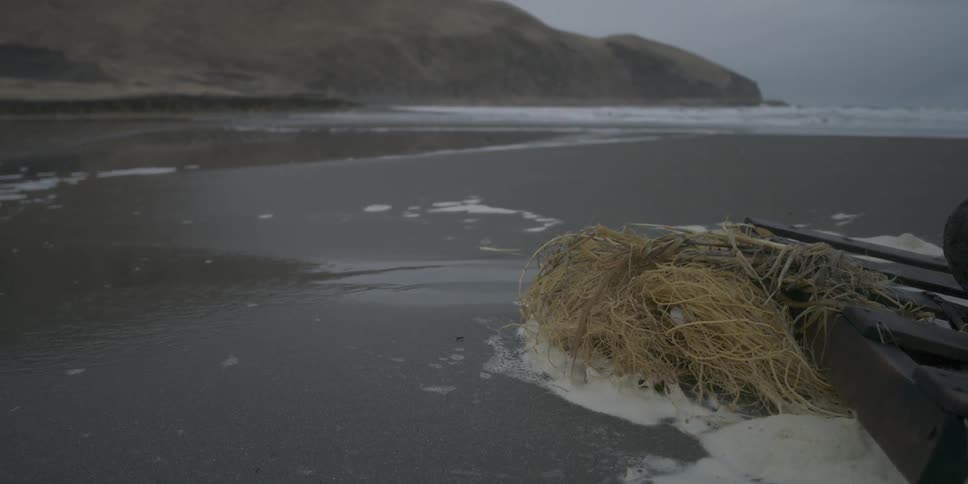 Ocean waves wash ashore an icy beach