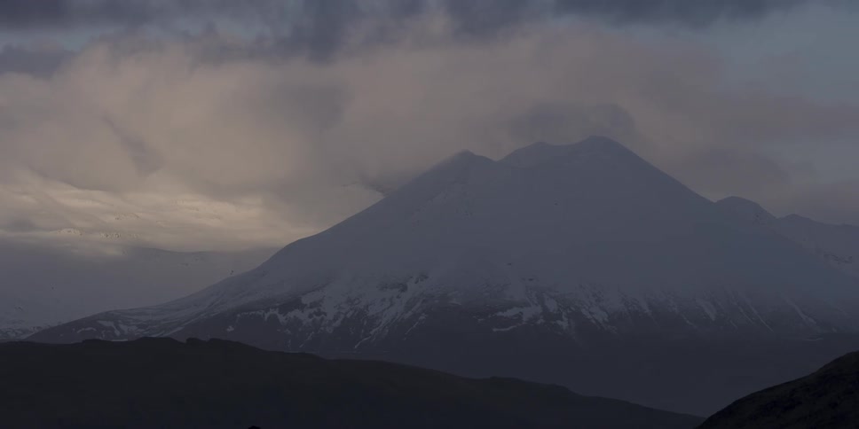 The clouds roll over the top of the mountain