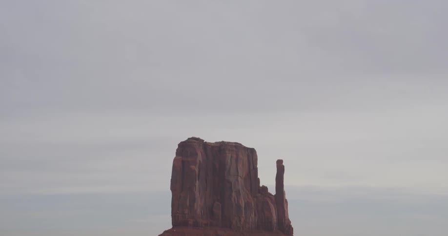 A rock formation stands tall in the desert