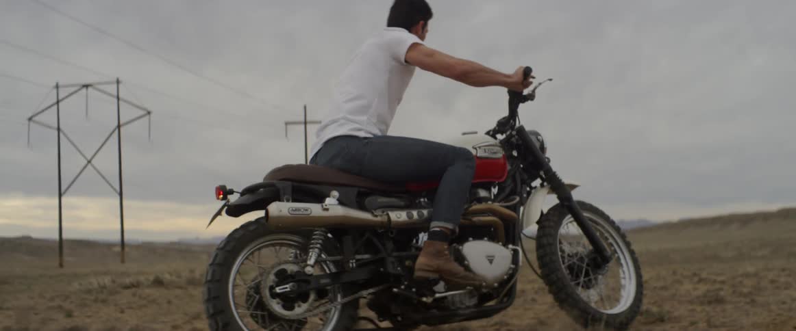 A man rides a motorcycle in the dirt