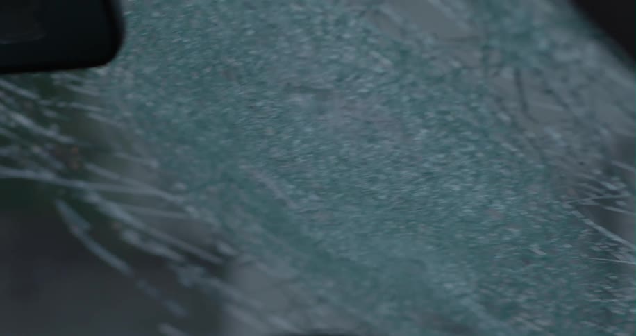 A baseball bat smashes a car windshield