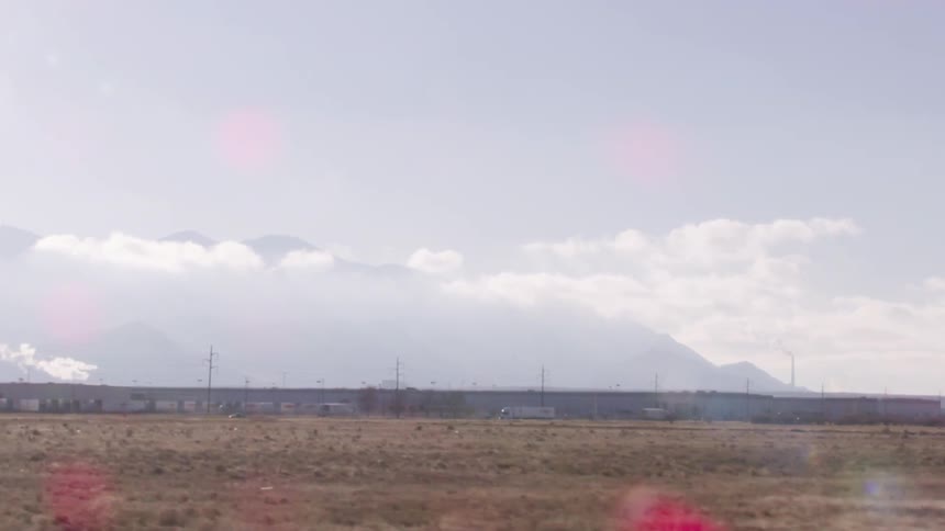 The long field leads to some trailers in the desert