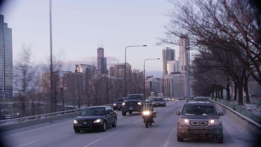 A busy city street lined with trees