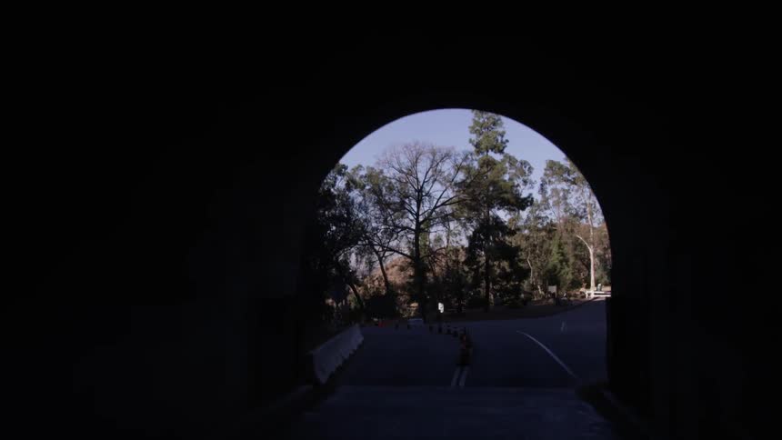 A vehicle drives through a tunnel