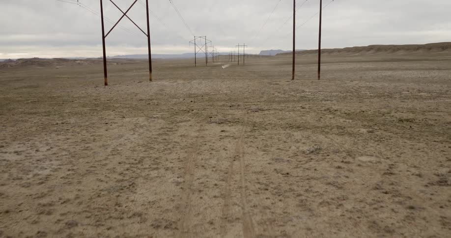 Power lines stand in a rural field
