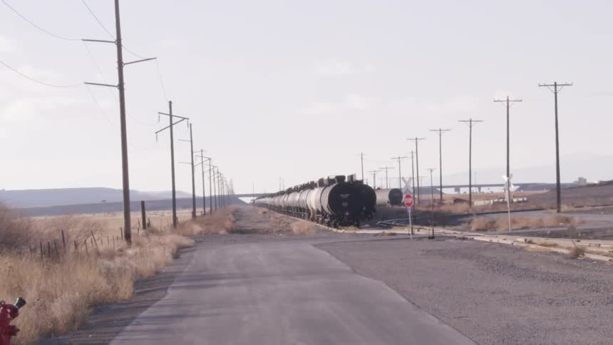 The tankers are lined up by the side of the road ahead