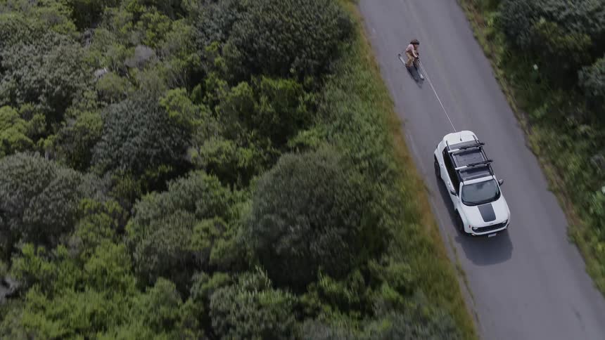 A person is being pulled on skis behind a vehicle