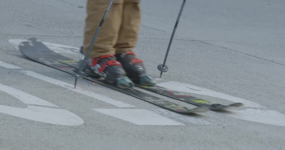 Person skiing down a street