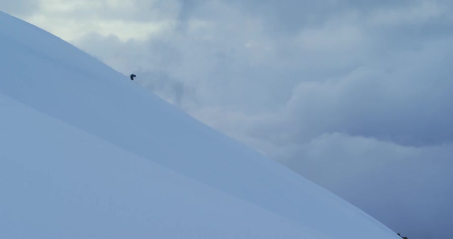 A person skis down a mountain slope