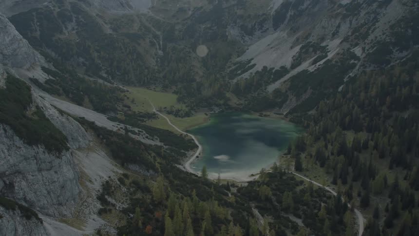 Water sits between the tall mountains