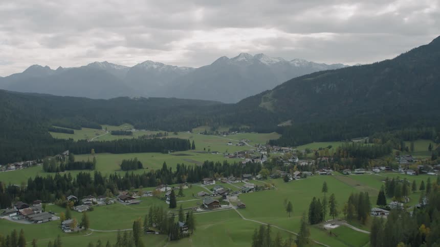 Houses and roads sit in a green valley