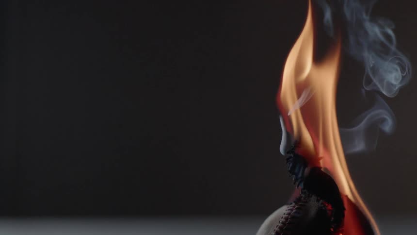 A baseball burns in an empty room