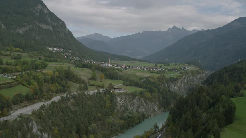 A stream runs alongside a mountain valley village