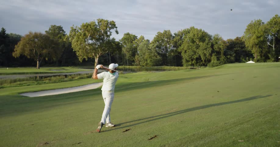 A man drives the ball down the golf course