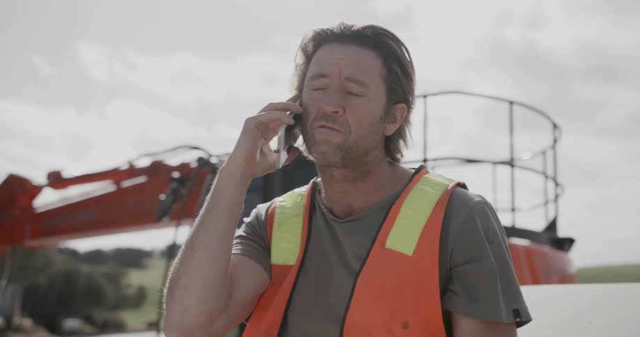 A man is talking on the phone outside
