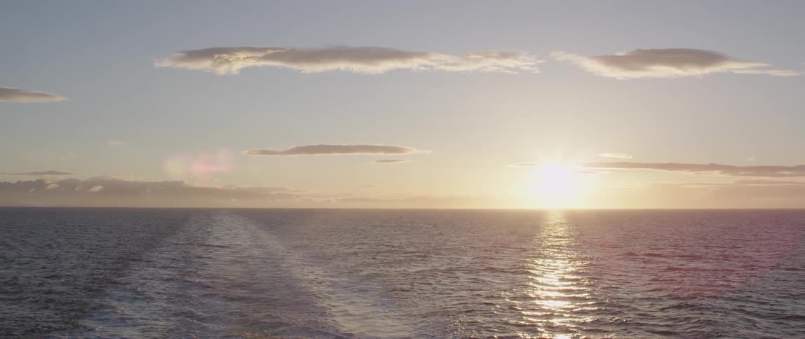 The sun rises over the ocean waters