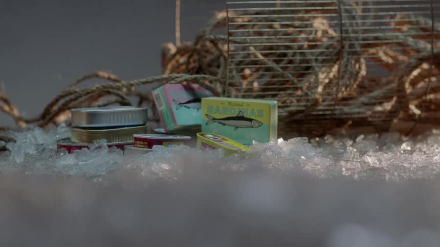 Canned seafood trash is scattered on the ice