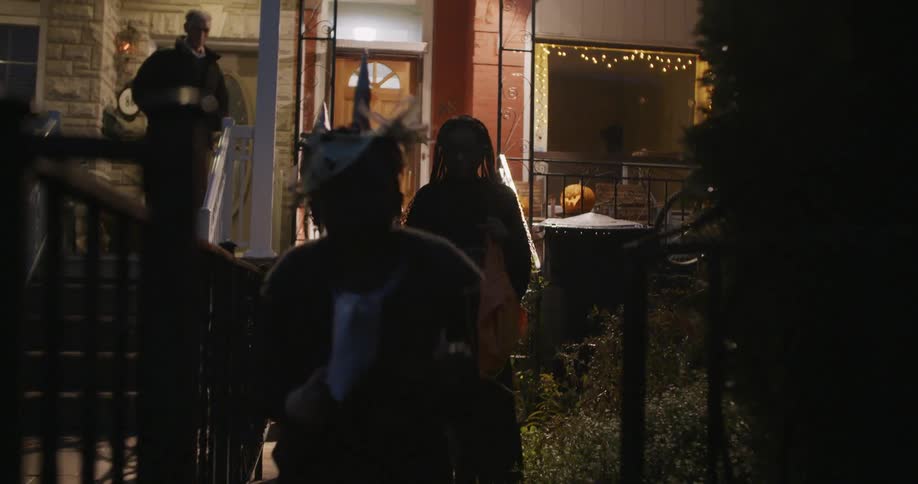 Trick or treaters leave a home at night