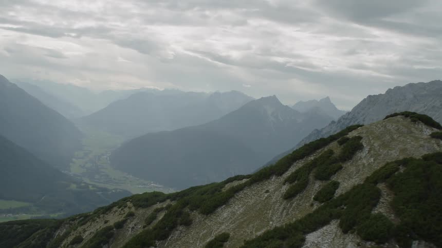 Trees dot the ridge of a mountain in a range