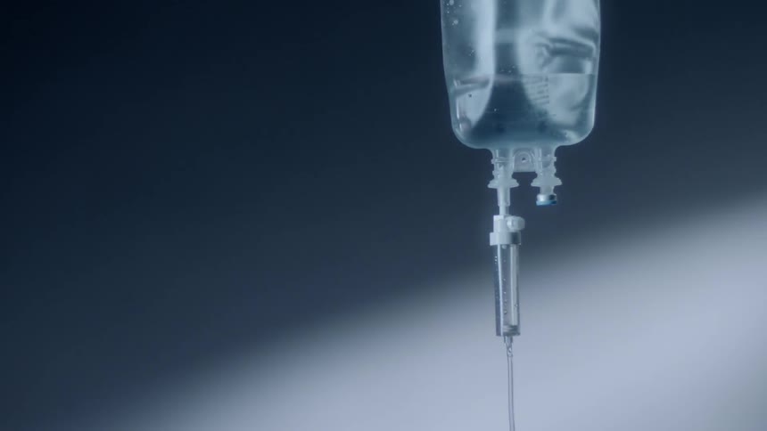 Liquid in an iv bag drips down the tube