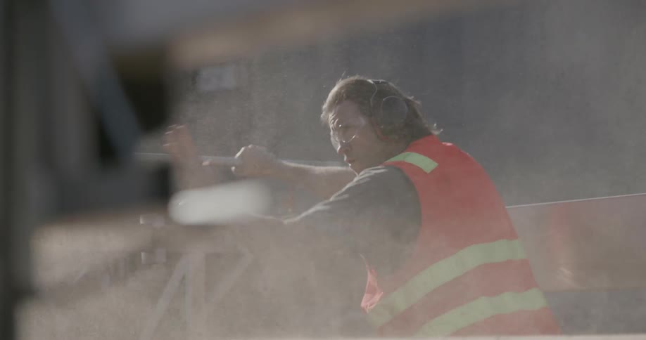 A man uses his hands to give instruction at a construction site