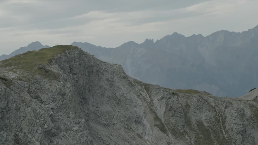 Grass grows on the ridge of a mountain