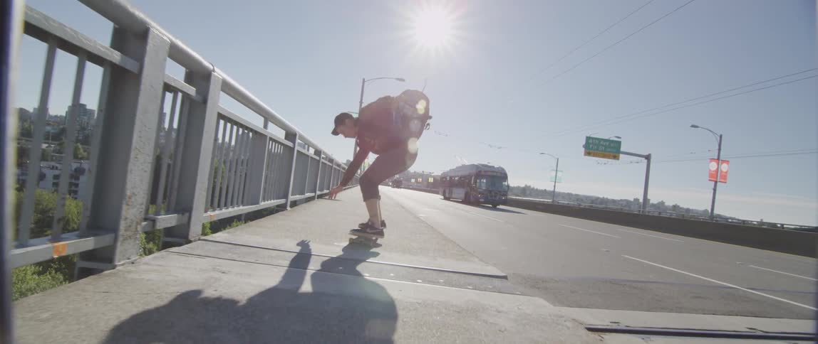 Skateboarder does ollie on city sidewalk