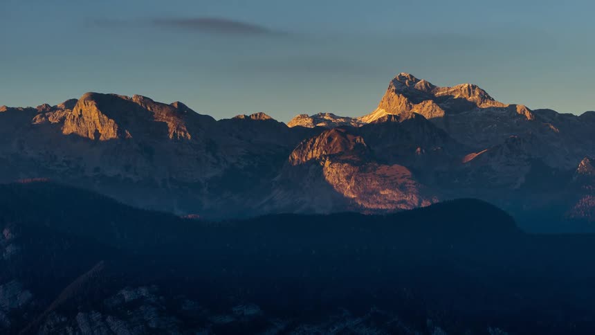 Sunset view from the top of the Vogel mountain in Slovenia with clouds passing overhead