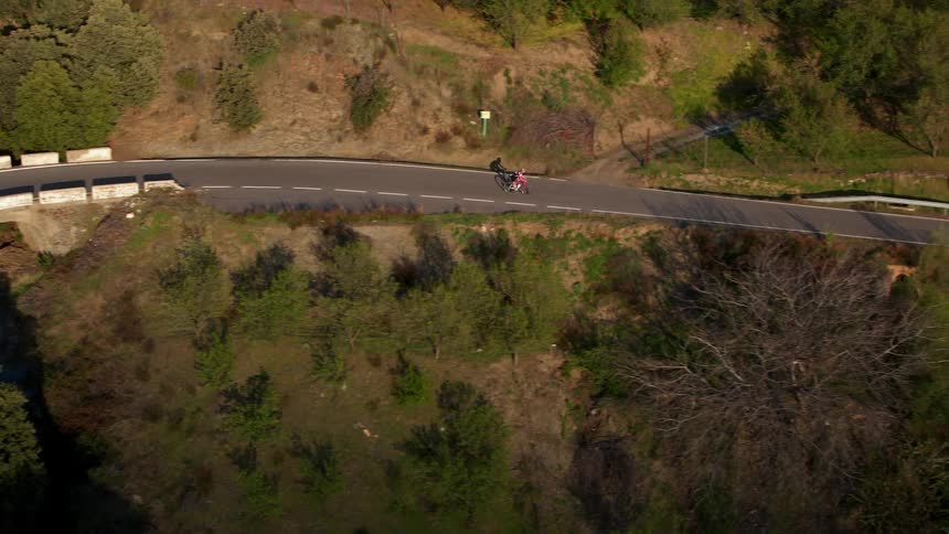 A bicyclist rides down a mountain road in the south of Spain
